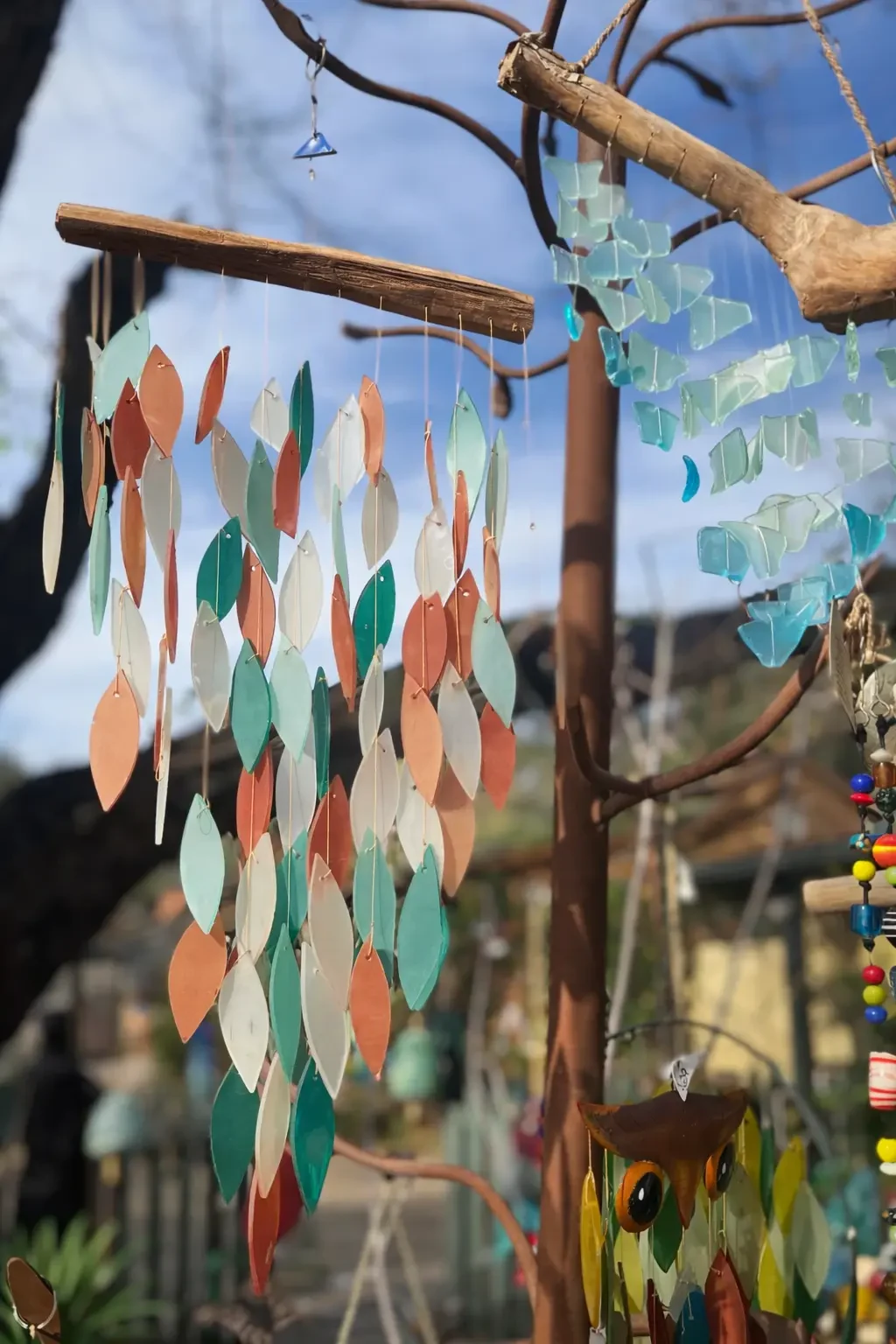 Colorful glass fish and sea-glass garden chimes displayed at Mi Amoré Sedona
